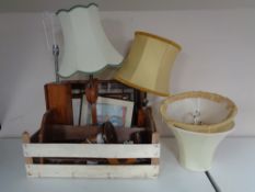 A box containing framed pictures, mid twentieth century teak table lamps,