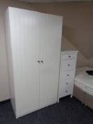 An Ikea Risdal double door wardrobe together with a painted pine Ikea five drawer chest