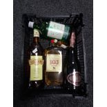 A basket containing a bottle of Cassons gin, two bottles of brandy,