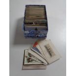 A box containing antiquarian and later postcards to include silk examples