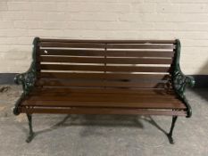 A cast iron wooden slatted garden bench