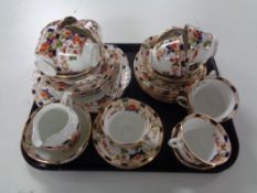 A tray containing forty pieces of antique floral patterned tea china