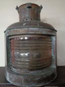 An antique copper ship's bulkhead lamp - Port