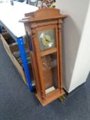 A contemporary oak cased Clockworks quarter chiming wall clock with weights and keys