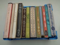 A crate containing 12 Folio Society volumes to include Utopia, The Trial of John Bunyan,