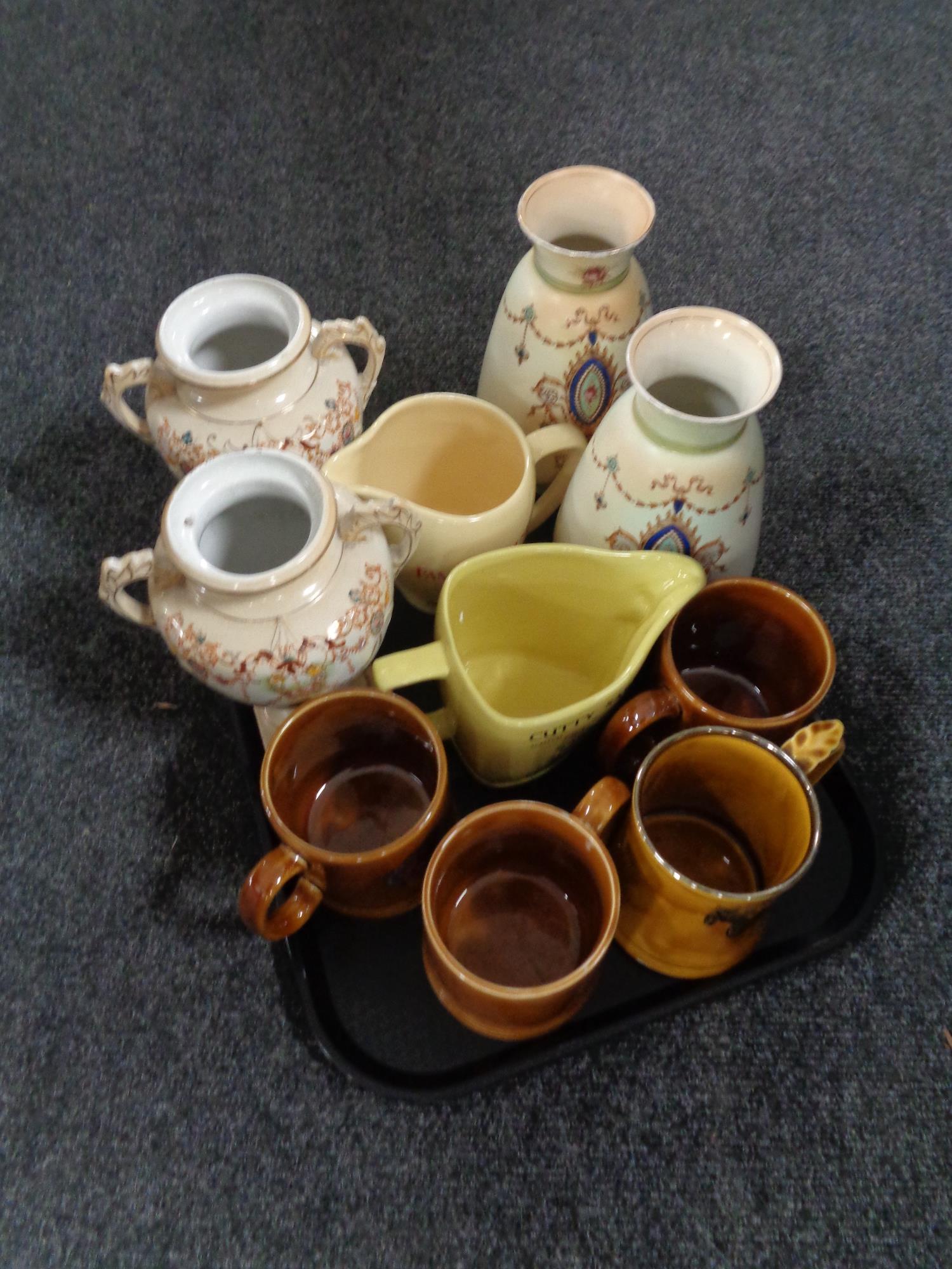 A tray containing Nelson pottery tankards, Wade whiskey jugs,