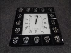 A contemporary wall clock with skull decoration