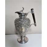 A 19th century embossed silver plated claret jug.