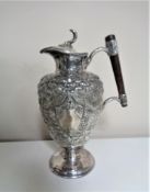 A 19th century embossed silver plated claret jug.