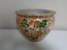 An oriental style fish bowl planter.