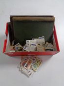 A shoebox containing Brooke Bond tea cards, an album of stamps and further collectors cards.