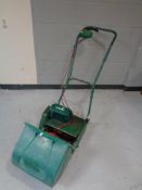 A Qualcast Suffolk electric lawn mower with box and extension lead