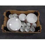 A box containing 40 pieces of white silver rimmed dinner ware.