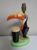 A Carlton ware Guinness 'How Grand to be a Toucan: Just think what toucan do' table lamp (AF).