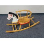 A wooden toddler's rocking horse chair.