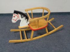 A wooden toddler's rocking horse chair.