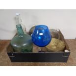 A box containing assorted glassware to include Demijohn Smirnoff vodka bottle, dishes etc.