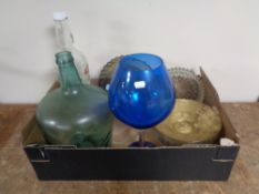 A box containing assorted glassware to include Demijohn Smirnoff vodka bottle, dishes etc.