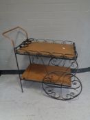 A 20th century hammered copper and iron two tier tea trolley