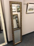 A 5' by 1' hall mirror in decorative gilt frame