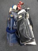 Three golf bags containing a large quantity of assorted golf clubs to include irons, drivers,