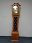 A Tempus Fugit longcase clock with pendulum and weights.