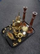 A tray of brass to include hand bell, miniature candlesticks, a pair of wooden candlesticks.