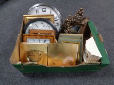 A box containing contemporary framed prints and mirrors, sorted wall clocks,