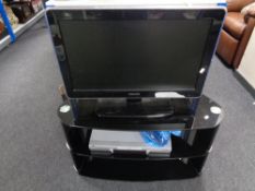 A Phillips 26 inch LCD TV on stand together with a JVC DVD player.