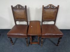 A pair of Edwardian dining chairs with leather upholstered seats,