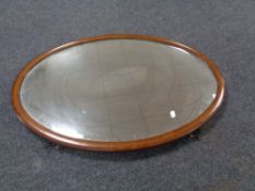 An early 20th century inlaid mahogany oval mirror.