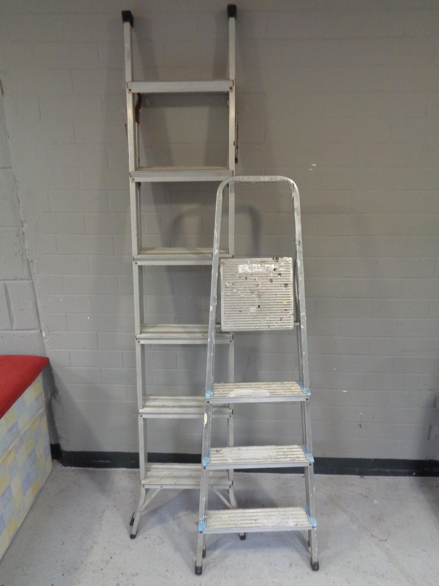 A folding aluminium ladder together with a set of Beldray folding aluminium steps