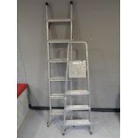 A folding aluminium ladder together with a set of Beldray folding aluminium steps