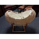 A Mamas and Papas Moses basket on stand.