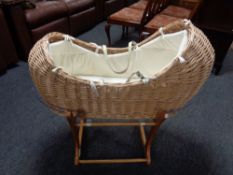 A Mamas and Papas Moses basket on stand.