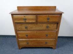 An Edwardian oak five drawer chest.