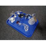 A tray containing Waterford Crystal clock, dolphin ornaments, glass paperweight etc.