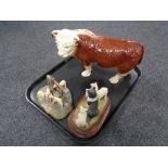 A tray containing a china figure of a Hereford bull,