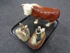 A tray containing a china figure of a Hereford bull,