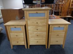 A contemporary pine narrow five drawer chest together with pair of matching three drawer bedside