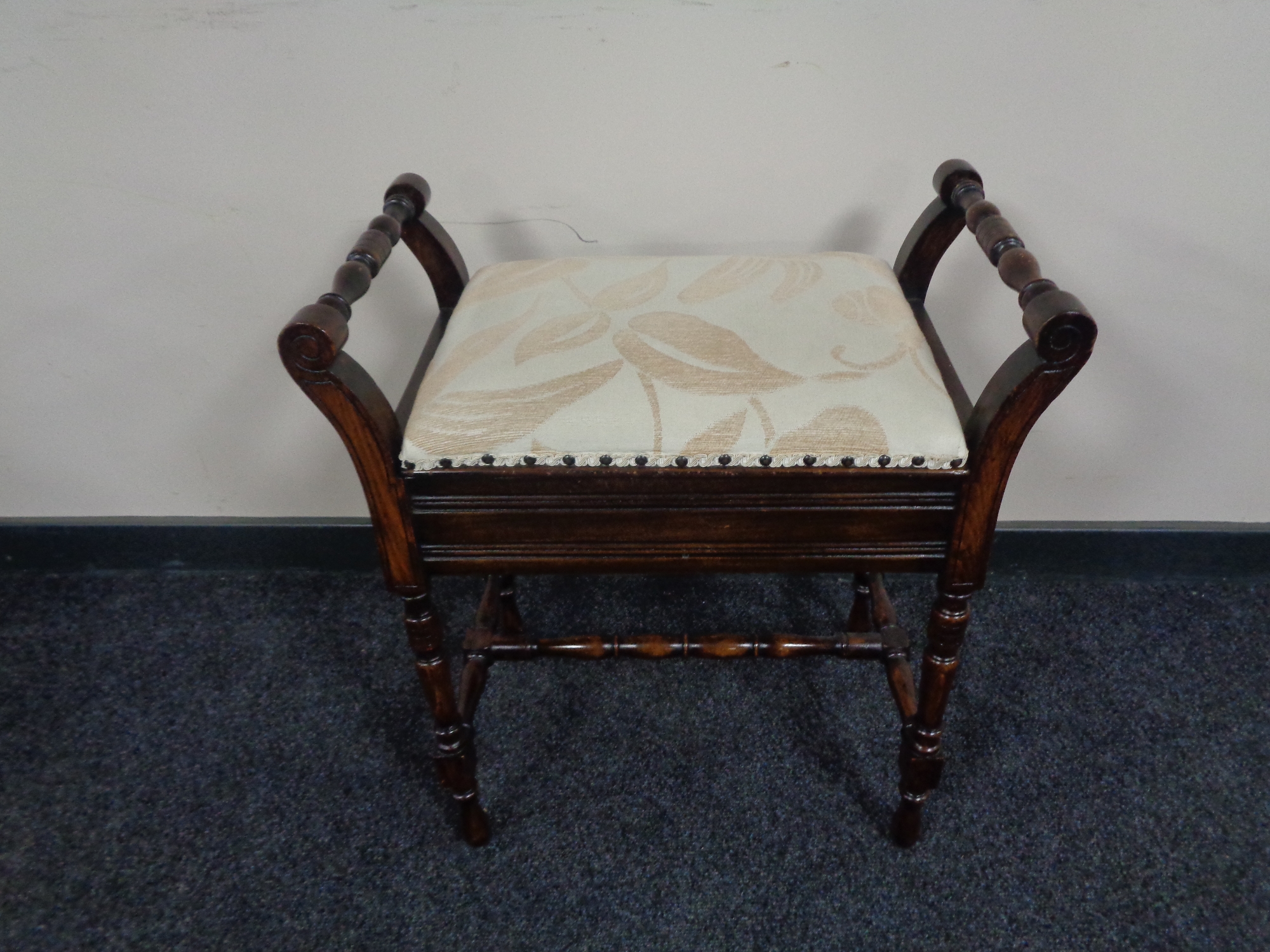 An Edwardian storage piano stool.