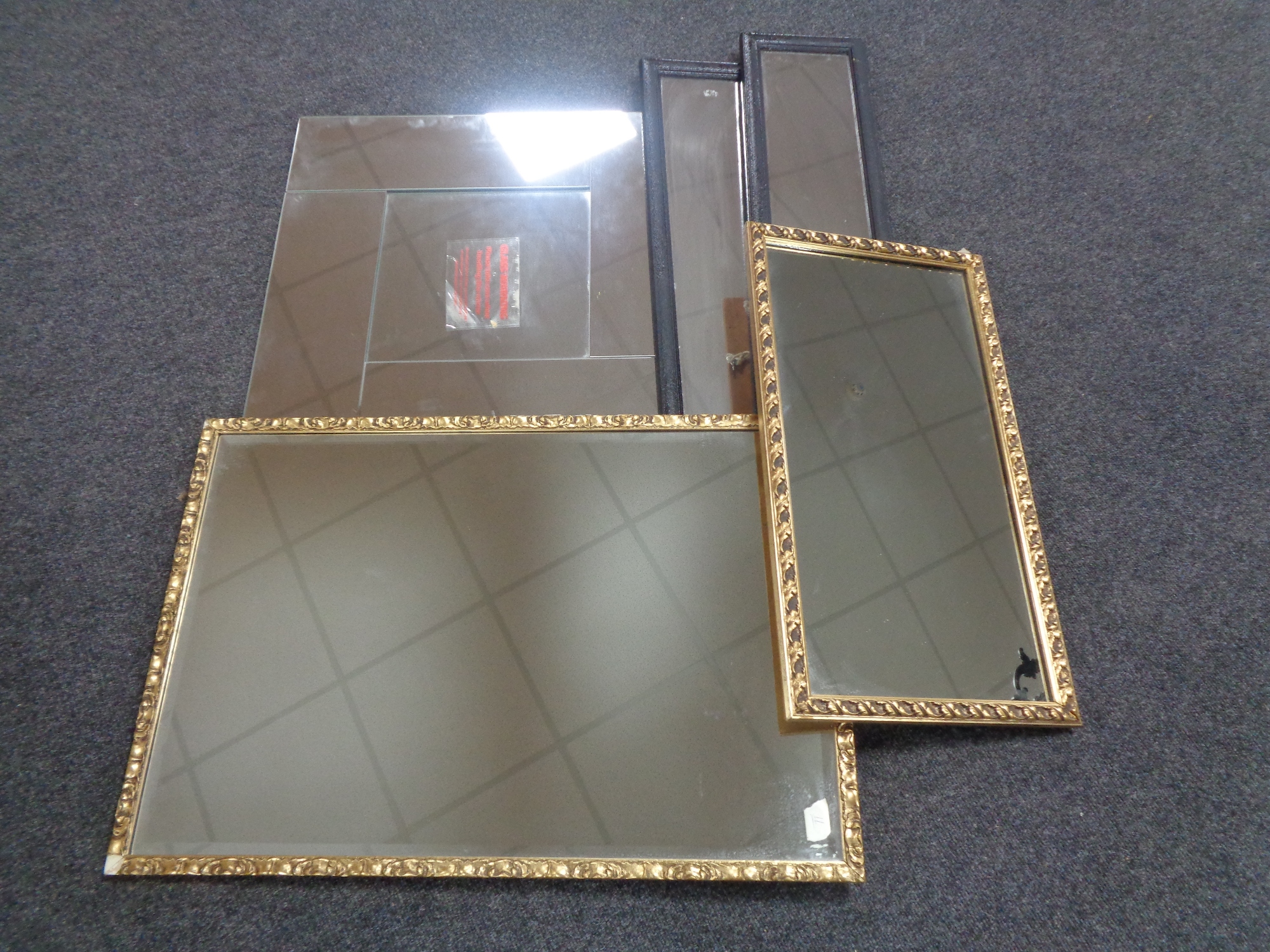 Two gilt framed mirrors together with an all glass framed mirror and two hall mirrors.