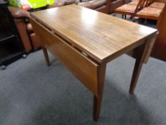 A rubber wood drop leaf kitchen table.