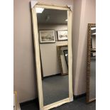 A 6' by 2' mirror in cream swept frame