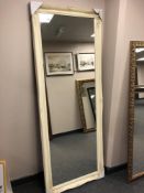 A 6' by 2' mirror in cream swept frame