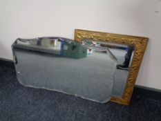 A brass embossed framed bevel edge mirror together with two frameless mirrors.