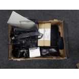 A box containing Olympus camera, Miranda lens, with other further cameras, an NEC fax machine etc,