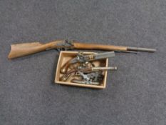 A replica Dutch flintlock rifle together with a box containing three replica flintlock pistols and