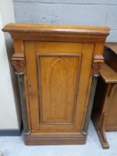 An antique oak Gothic style single door cupboard