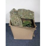 A box containing a quantity of army surplus items.